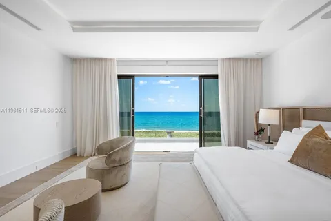 a front view of a house with garden and lake view