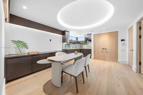 a view of a house with a yard and palm trees