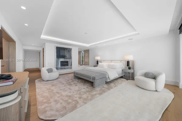a view of a dining room with furniture a chandelier and windows
