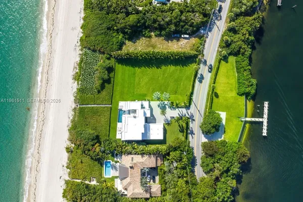 a view of a house with backyard and swimming pool
