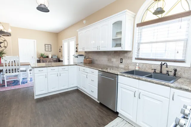 a kitchen with sink cabinets and window