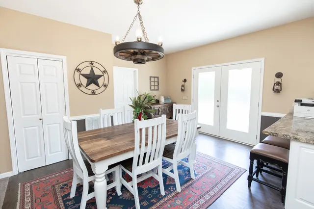a view of a dining room with furniture wooden floor and a chandelier