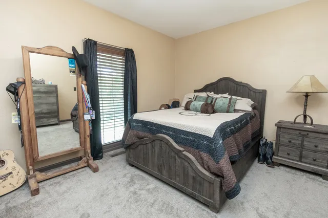 a bedroom with a bed and a night stand