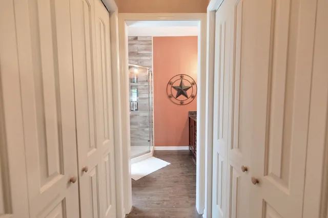 a bathroom with a granite countertop double vanity sink a mirror and a window