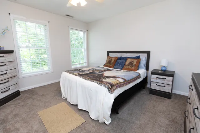 a bed sitting in a bedroom next to a window