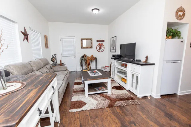 a kitchen with stainless steel appliances granite countertop a stove a sink dishwasher and cabinets with wooden floor