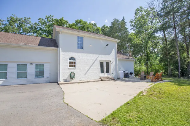 a view of a table and chairs in backyard of the house