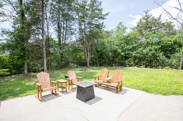 a view of a backyard with a garden and trees