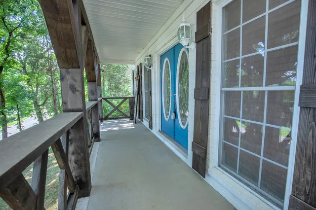 a view of balcony with floor to ceiling window and wooden floor