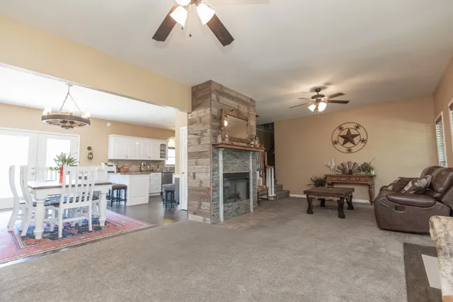 a living room with lots of furniture and chandelier