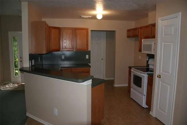 a kitchen with metallic refrigerator and a sink