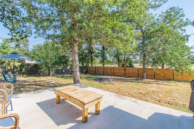 a view of a backyard with a tree