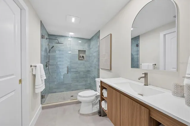 a bathroom with a sink a toilet and shower