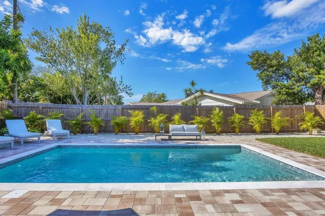 a view of yard with swimming pool and green space