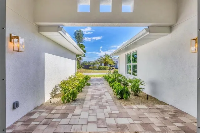 a entryway view with a flower garden