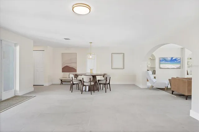 a living room with furniture and a dining table