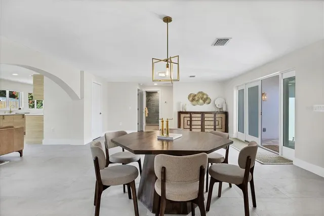 a view of a dining room with furniture and chandelier