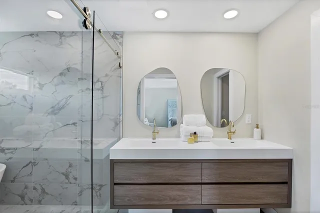 a bathroom with a sink double vanity and a mirror