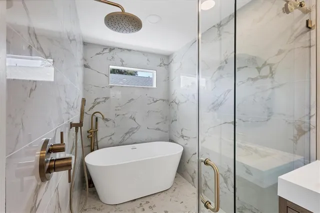 a bathroom with a bathtub and shower