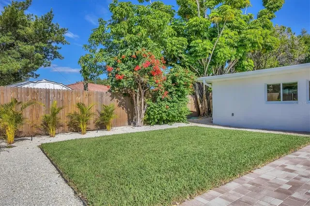 a front view of house with a garden