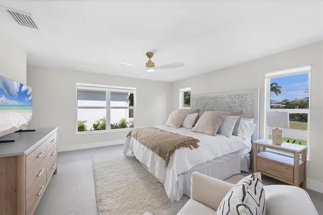 a spacious bedroom with a bed and a window