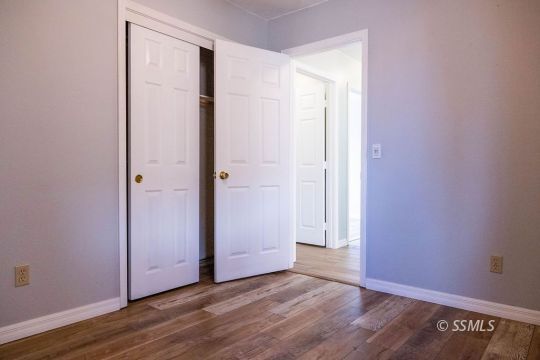 1012 Conejo Avenue Ridgecrest, CA 93555 - Photo 16 of 24 an empty room with wooden floor and closet