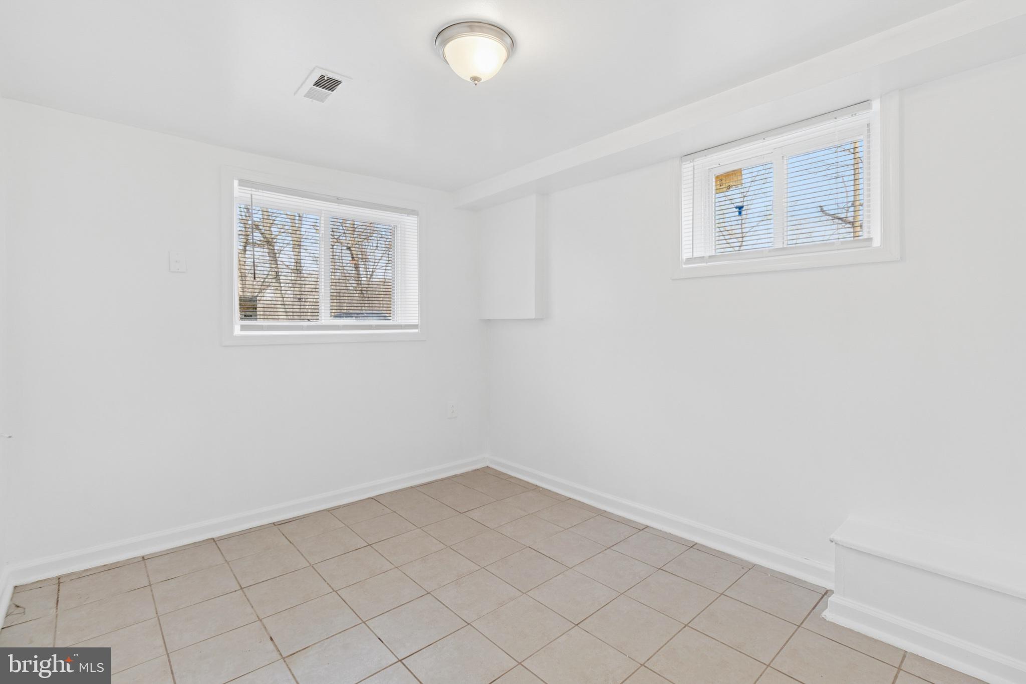 407 Lebaum Street Southeast, Unit 4 Washington, DC 20032 - Photo 11 of 18 an empty room with windows