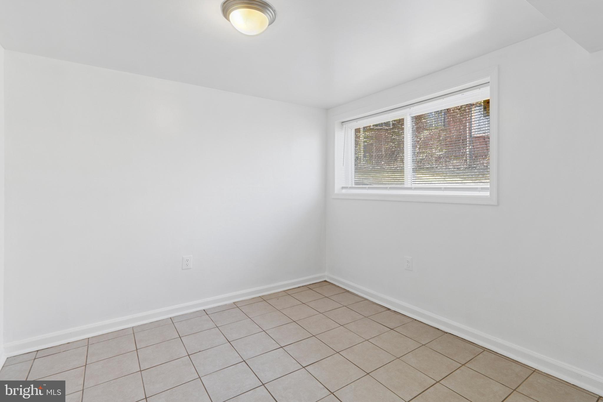 407 Lebaum Street Southeast, Unit 4 Washington, DC 20032 - Photo 15 of 18 an empty room with a window