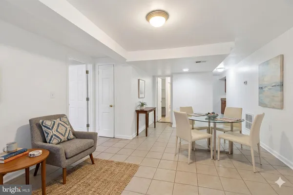 an empty room with kitchen view