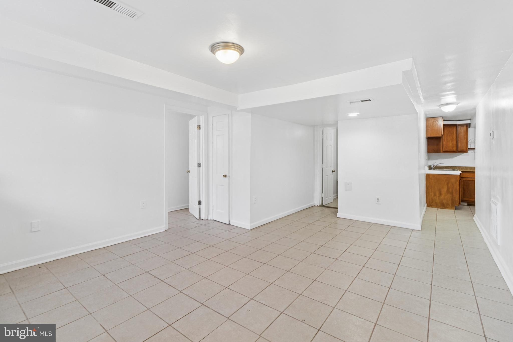 407 Lebaum Street Southeast, Unit 4 Washington, DC 20032 - Photo 4 of 18 an empty room with kitchen view