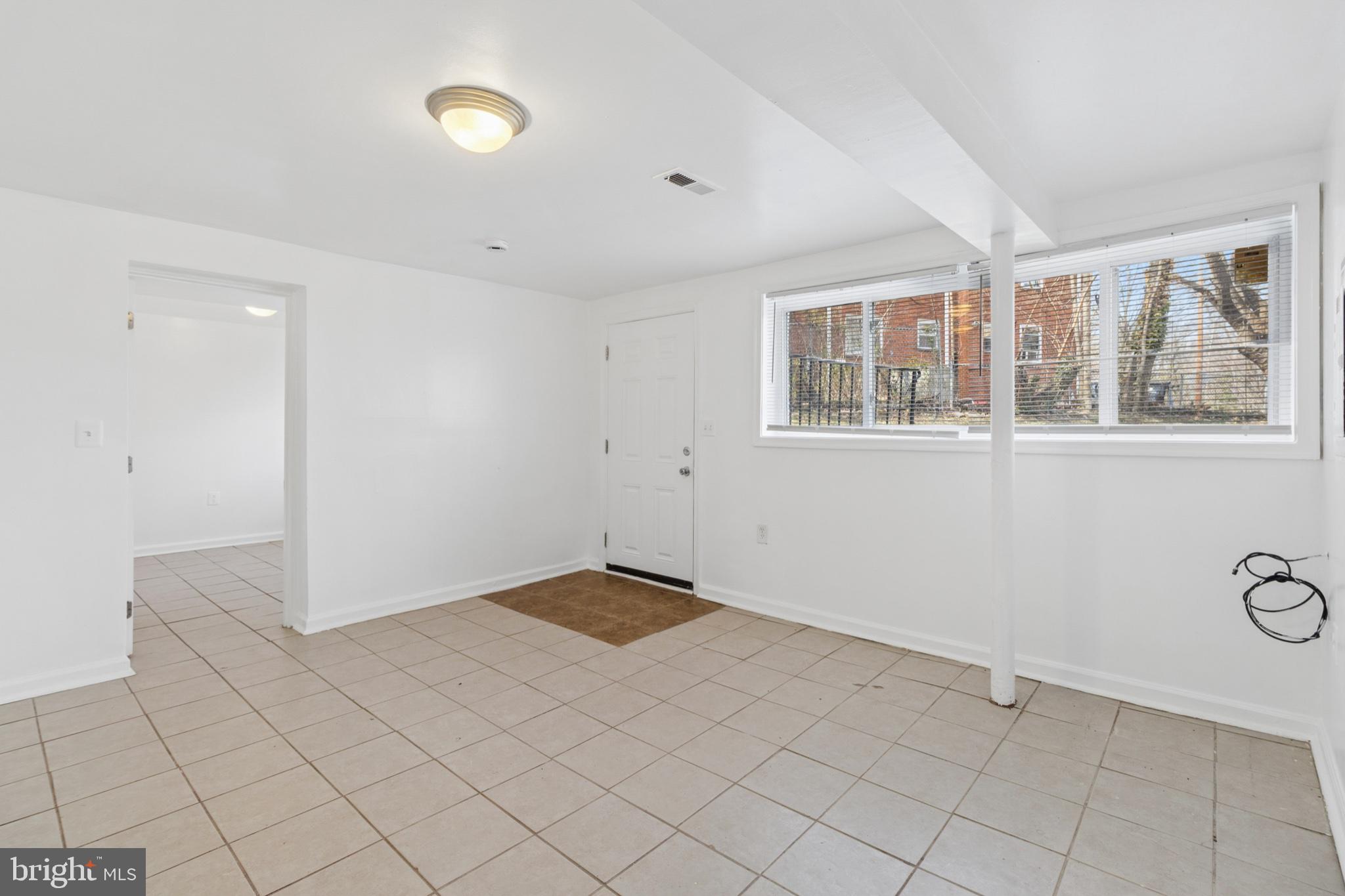 407 Lebaum Street Southeast, Unit 4 Washington, DC 20032 - Photo 6 of 18 a view of an empty room with a window