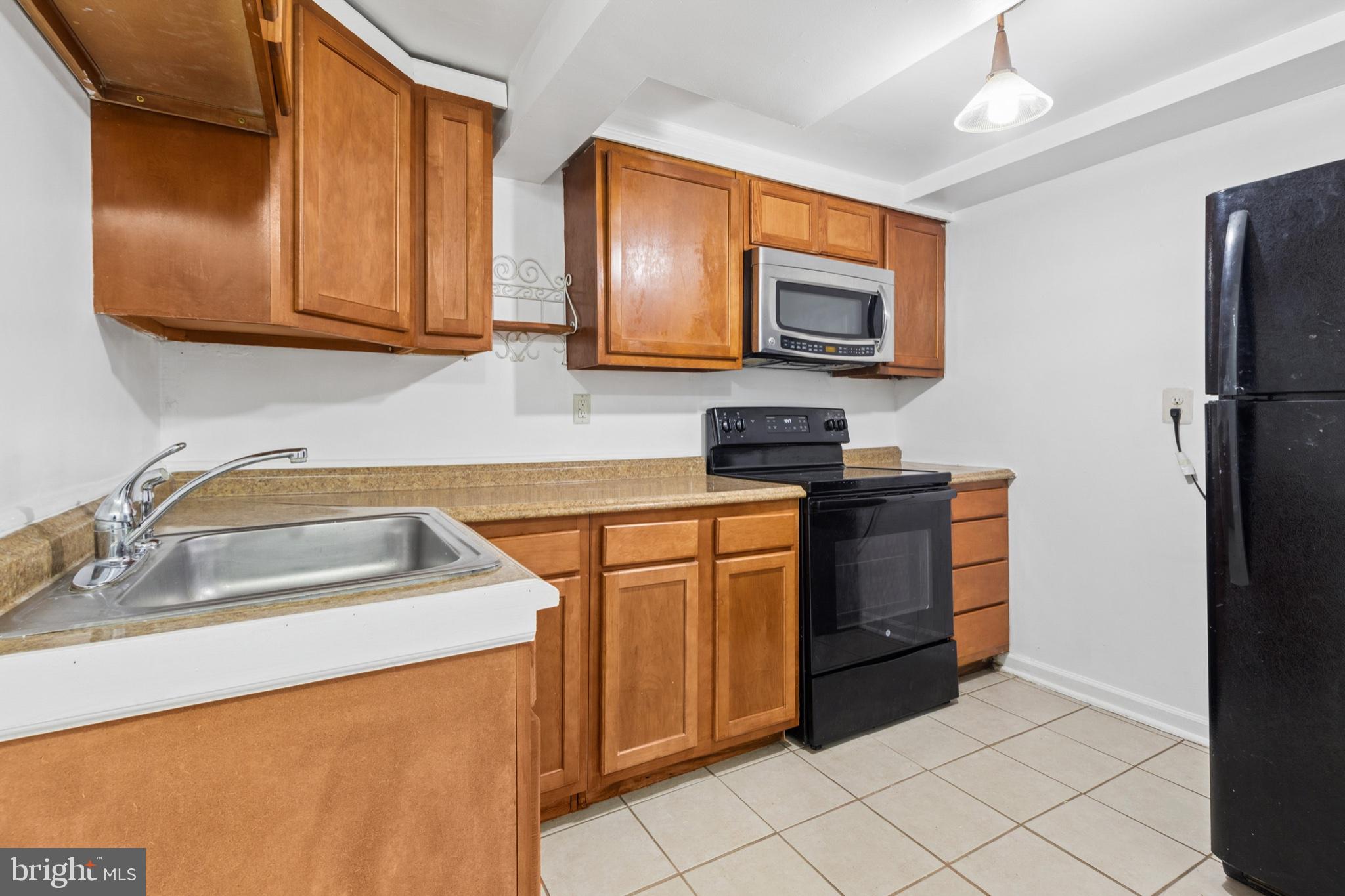 407 Lebaum Street Southeast, Unit 4 Washington, DC 20032 - Photo 7 of 18 a kitchen with stainless steel appliances granite countertop a sink stove and refrigerator