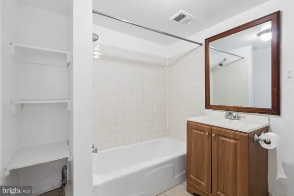 a bathroom with a sink vanity and toilet