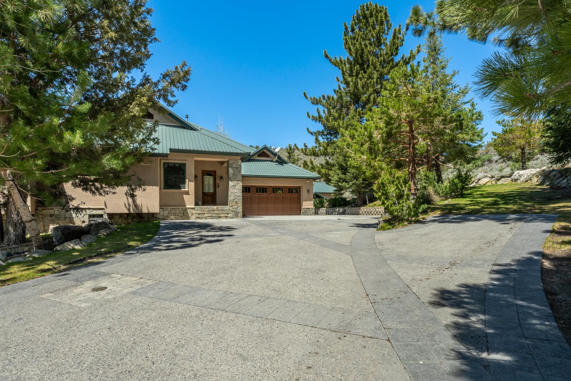 45 Skyline Road June Lake, CA 93529 - Photo 49 of 58 a front view of a house with a yard and garage