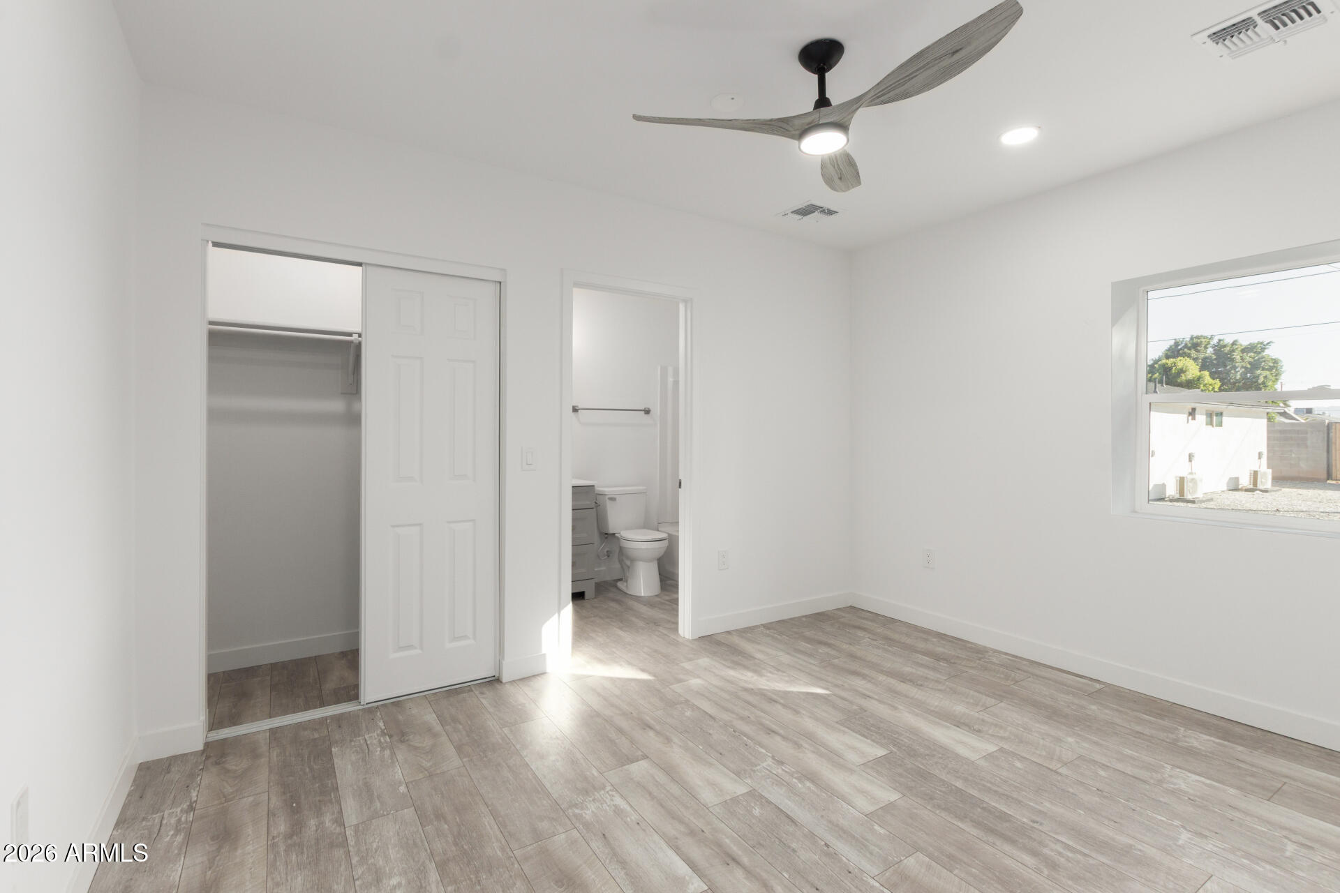 9309 West Adams Street Tolleson, AZ 85353 - Photo 12 of 29 wooden floor in an empty room with a window