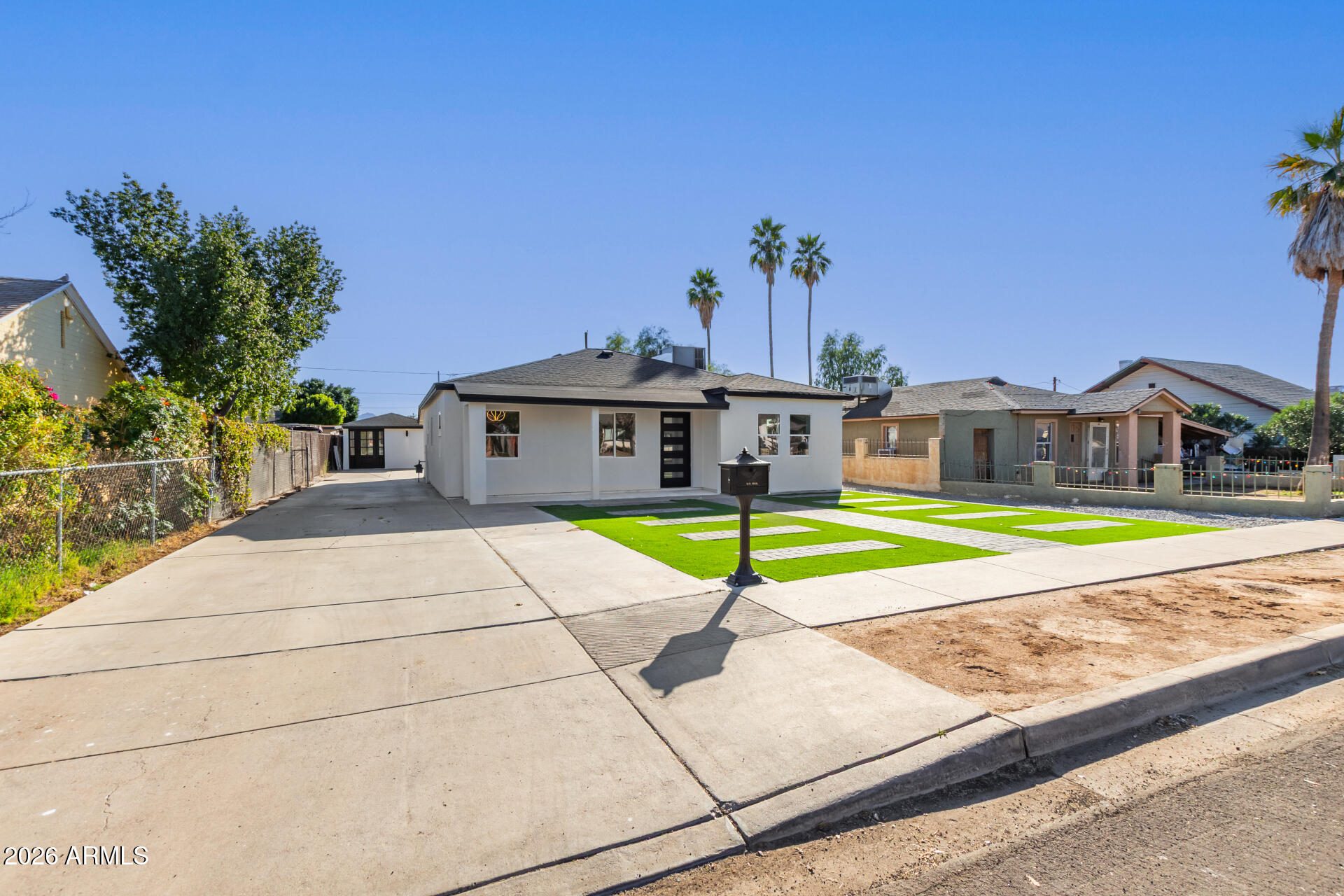 9309 West Adams Street Tolleson, AZ 85353 - Photo 2 of 29 a view of a house with a swimming pool