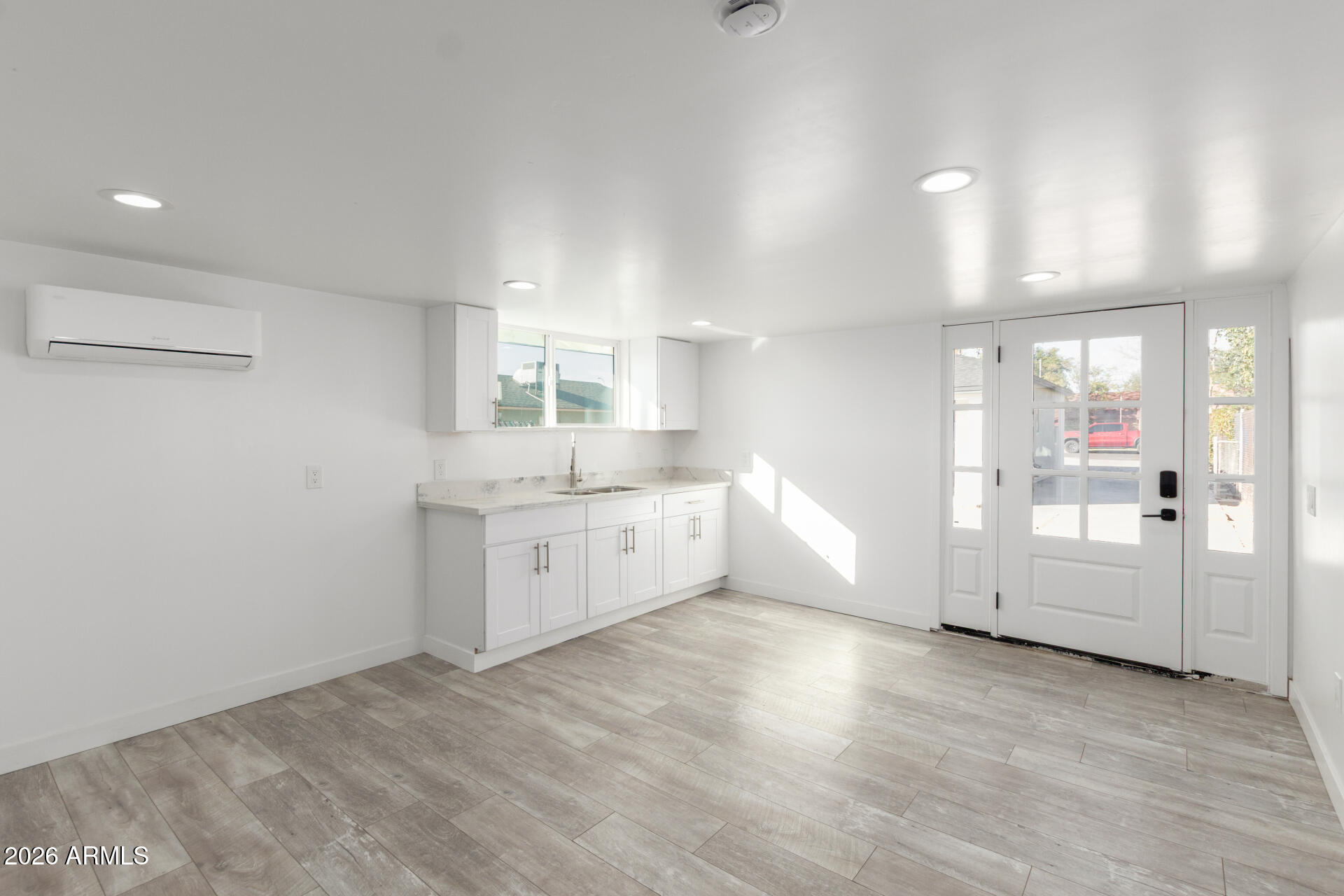 9309 West Adams Street Tolleson, AZ 85353 - Photo 21 of 29 a view of a kitchen with white cabinets and wooden floor