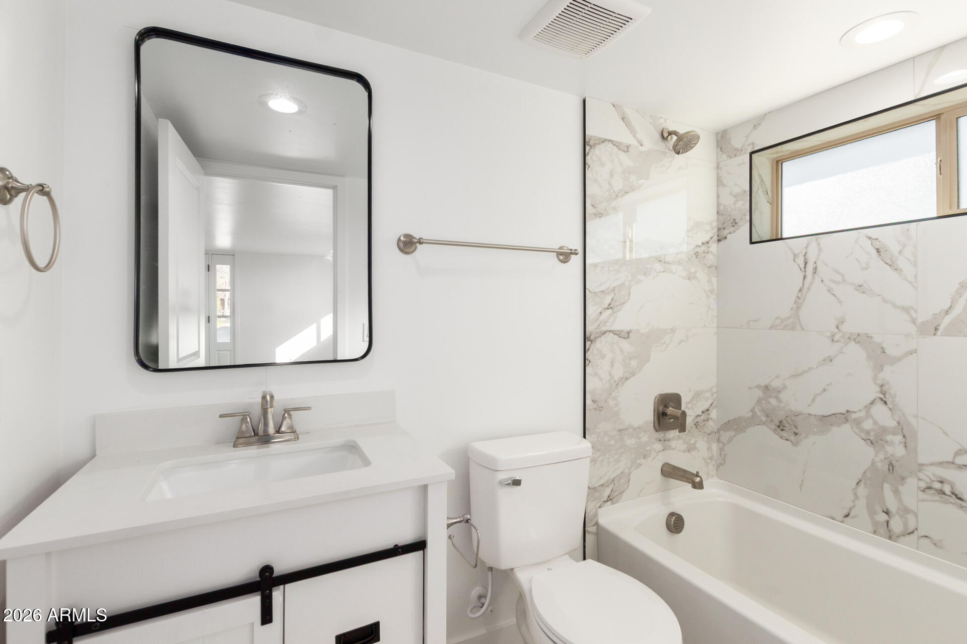 9309 West Adams Street Tolleson, AZ 85353 - Photo 23 of 29 a bathroom with a sink vanity mirror and toilet