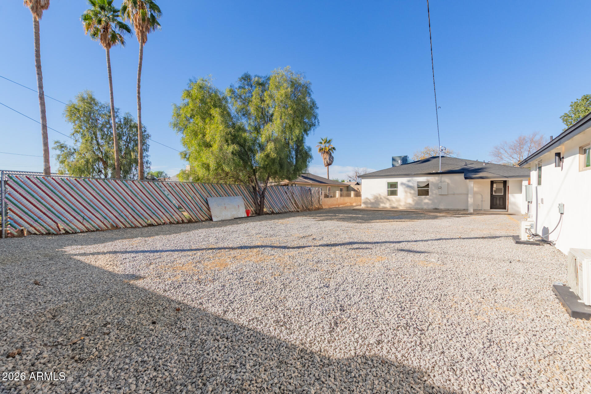 9309 West Adams Street Tolleson, AZ 85353 - Photo 29 of 29 a front view of a house with a yard and a garage