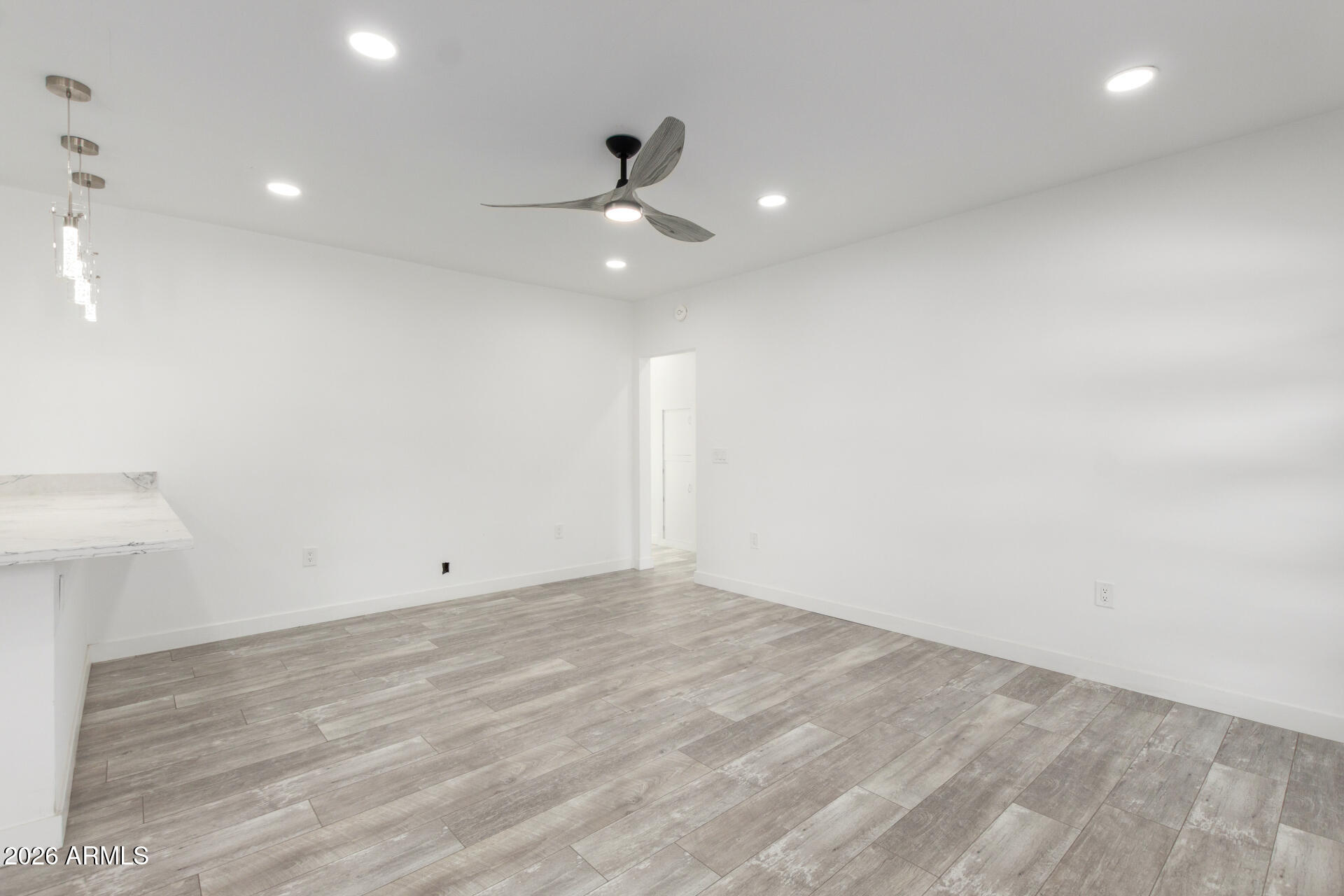 9309 West Adams Street Tolleson, AZ 85353 - Photo 6 of 29 an empty room with ceiling fan and window