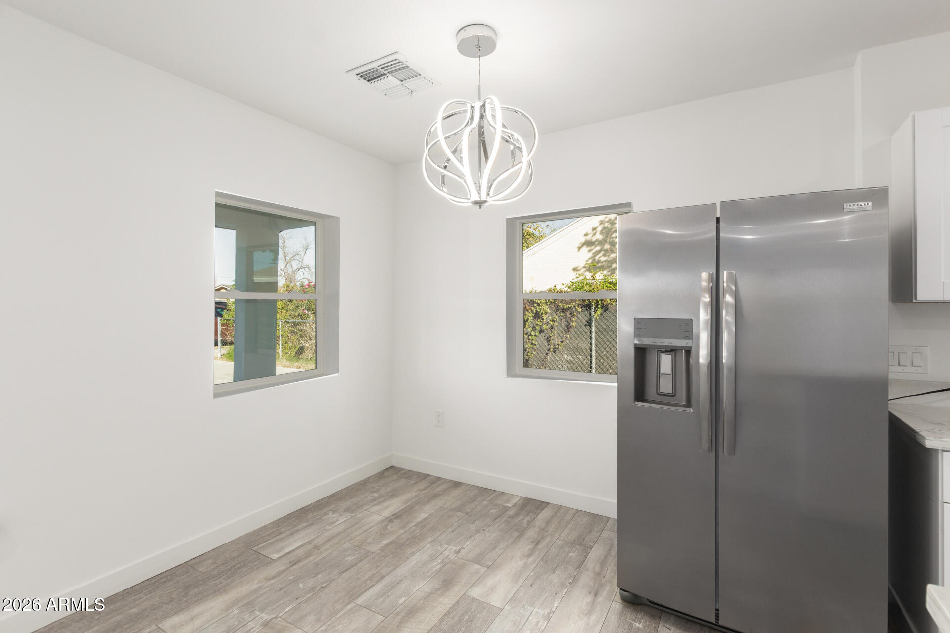 9309 West Adams Street Tolleson, AZ 85353 - Photo 7 of 29 a view of empty room with wooden floor and fan