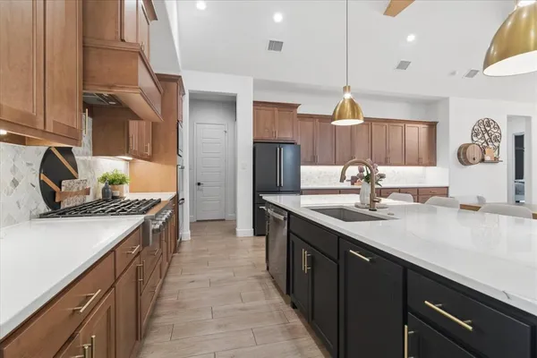a kitchen with a sink stove and refrigerator