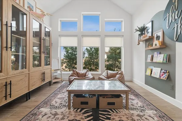 a living room with fireplace furniture and a large window