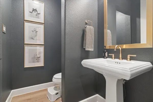 a bathroom with a sink toilet and mirror