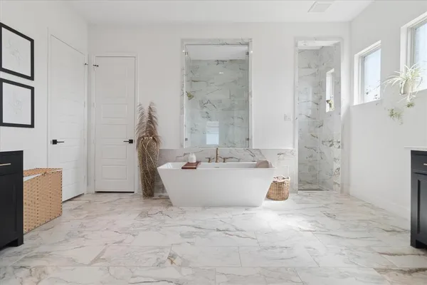 a view of bathroom with bathtub and shower
