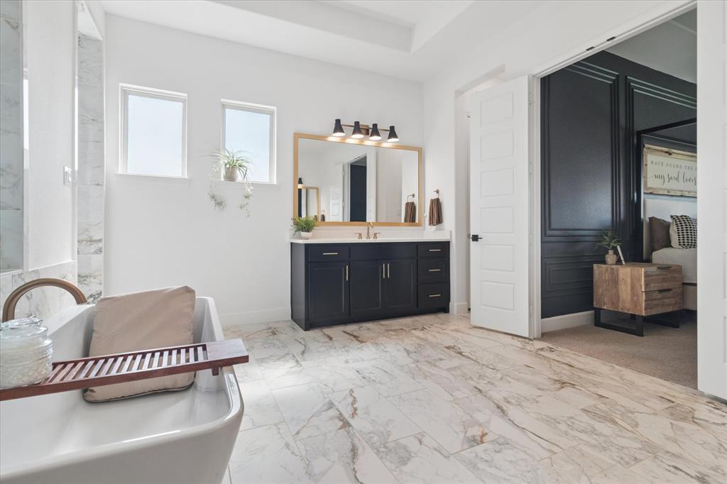 582 Broadleaf Way Haslet, TX 76052 - Photo 19 of 38 a spacious bathroom with a tub sink and mirror