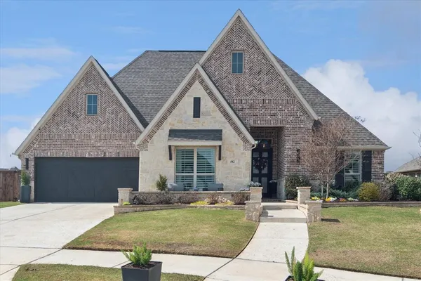 a front view of a house with a yard