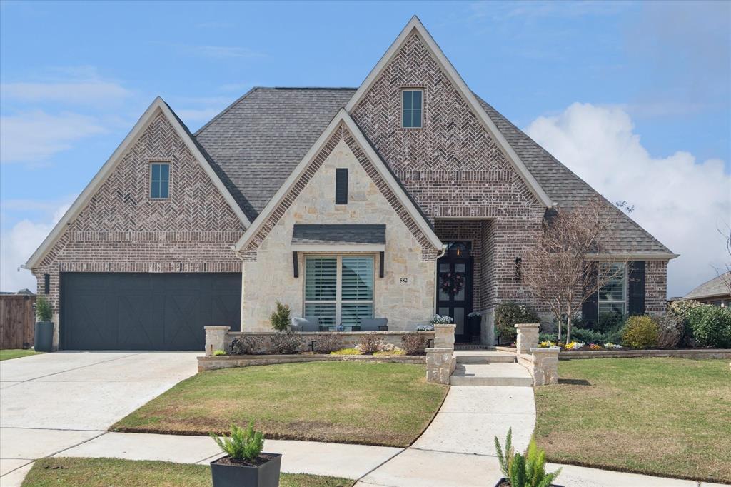 582 Broadleaf Way Haslet, TX 76052 - Photo 2 of 38 a front view of a house with a yard
