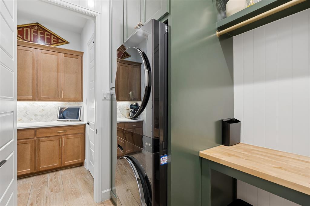 582 Broadleaf Way Haslet, TX 76052 - Photo 22 of 38 a utility room with cabinets washer and dryer