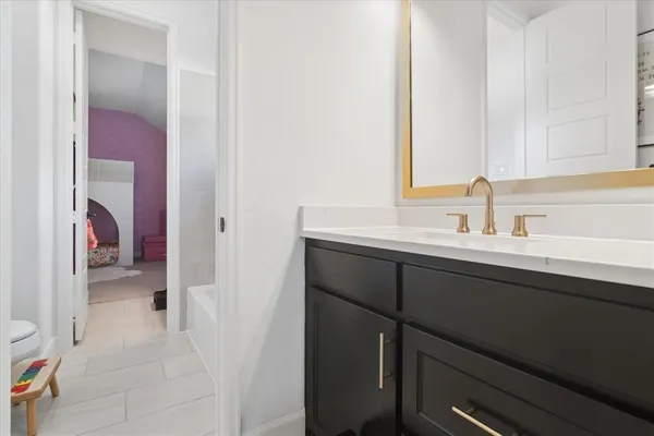 a en suite bathroom with a sink and a mirror